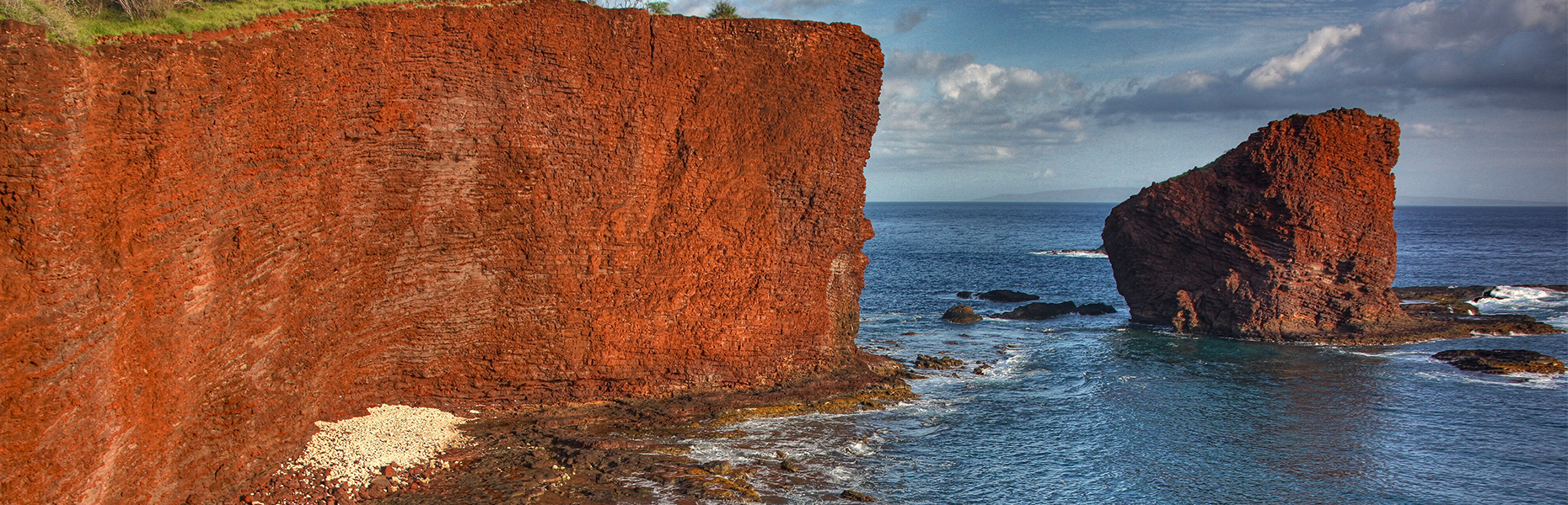 Rugged red rock cliffs above the ocean on Lānaʻi