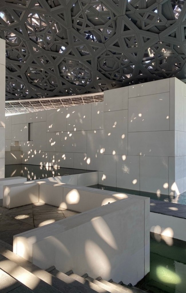 Dappled light falling through the dome of the Louvre Abu Dhabi