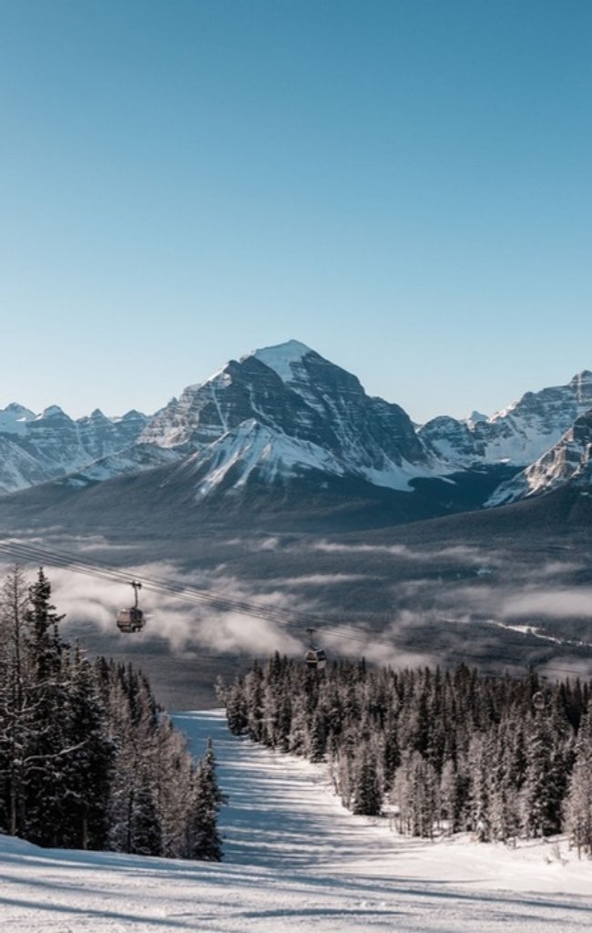 A ski run above the Bow Valley with snowy peaks beyond
