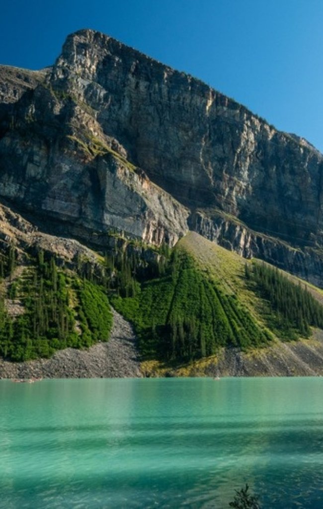 The turquoise water of Lake Louise below a rocky peak