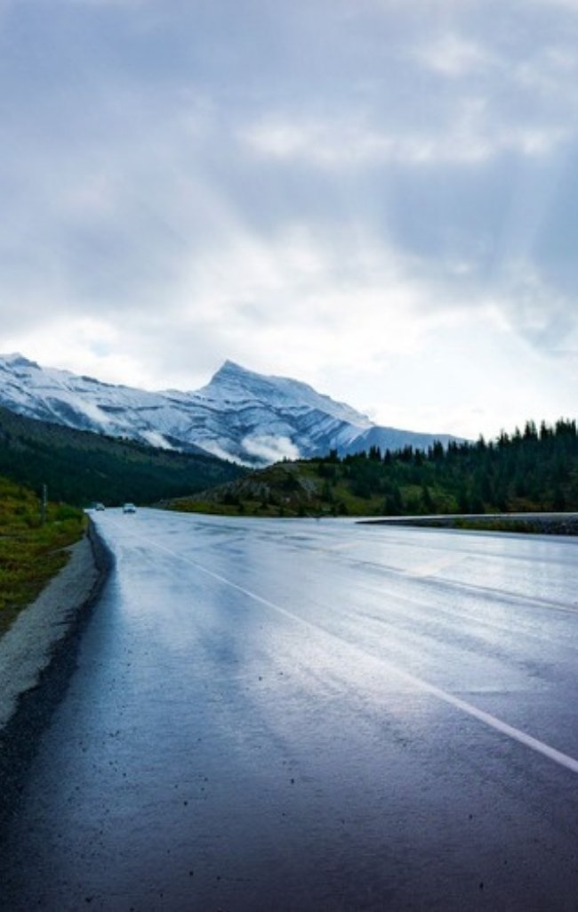 The Icefields Parkway winding toward snow-capped peaks near Jasper