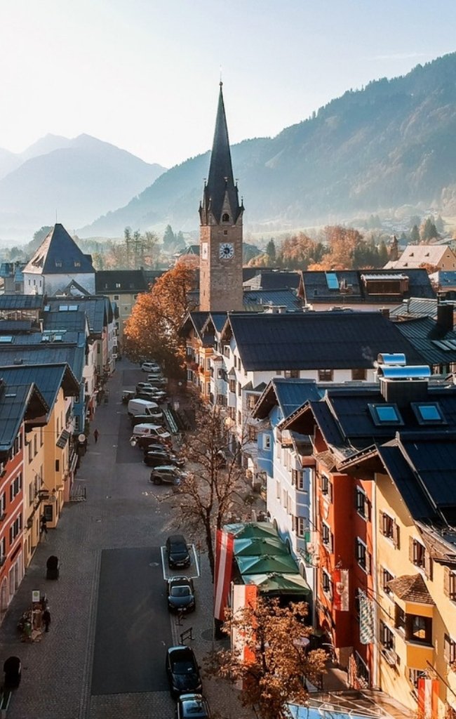 Church spire above the old town of Kitzbühel in autumn