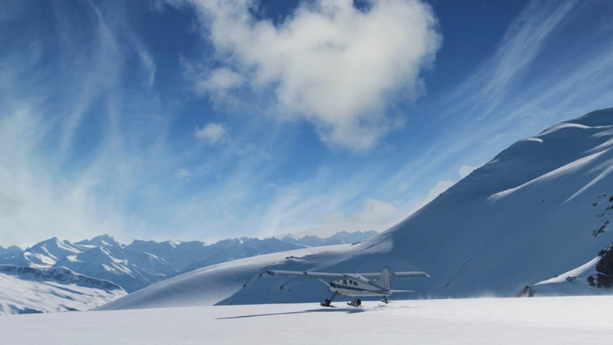 A ski plane on a snowfield among Alaska mountains