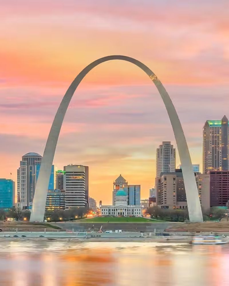 The Gateway Arch and St. Louis skyline on the Mississippi River at sunset