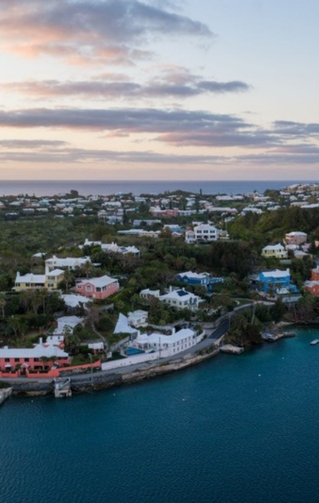 Colorful Bermudian homes along the water at dusk