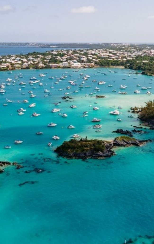Boats moored in a turquoise bay among small islands