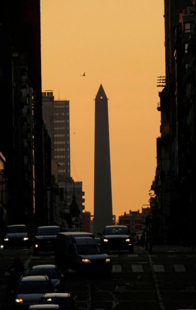 The Obelisco at sunset above traffic on Avenida 9 de Julio