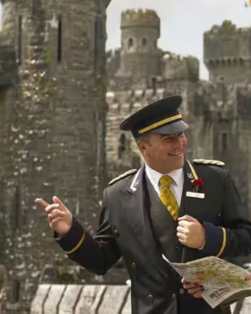 A uniformed guide pointing out the sights at a castle