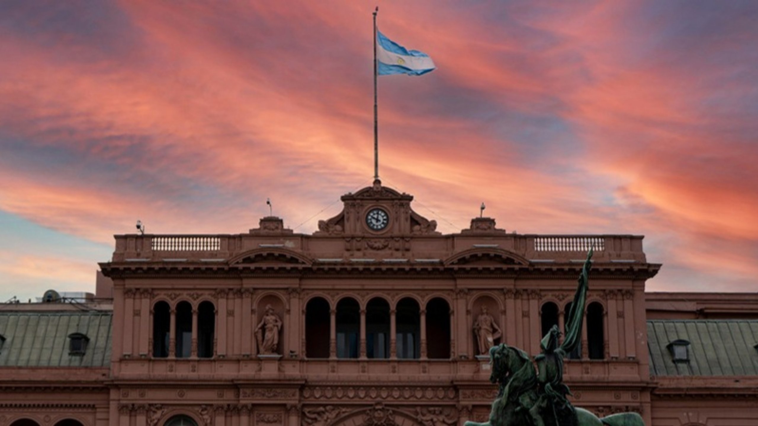 The Casa Rosada under a pink sunset sky in Buenos Aires