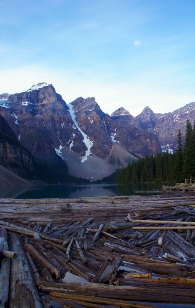 Moraine Lake below snowy mountains and forest