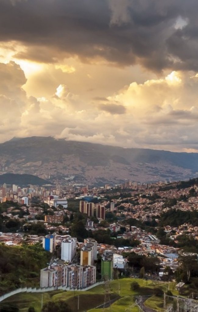 Medellín spreading across the Aburrá Valley at sunset