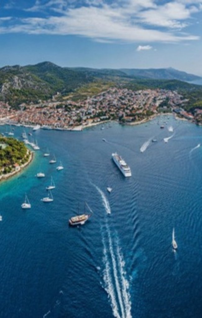 Aerial view of Hvar harbor with boats and the old town