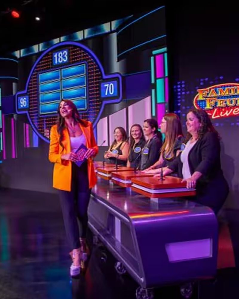 Contestants on stage at a Family Feud Live show