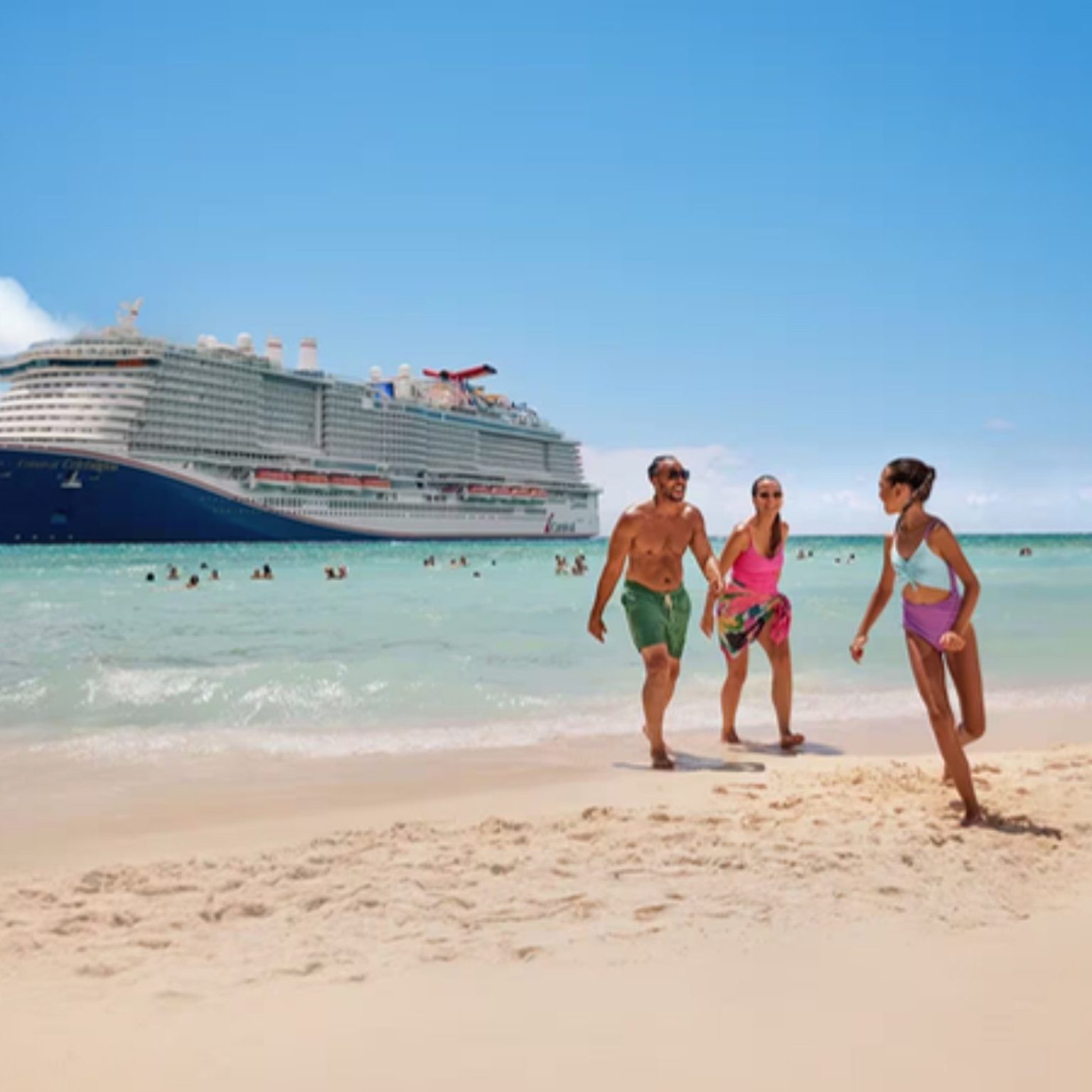 A Carnival ship anchored off a white sand beach as a family walks along the shore