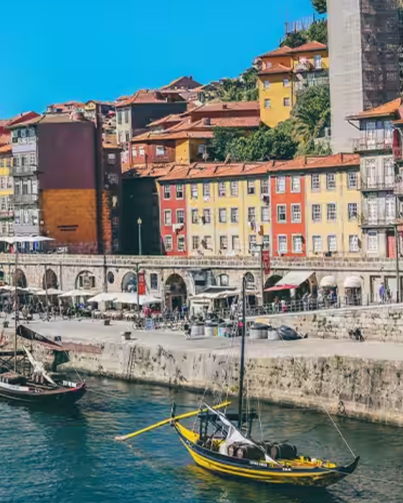 Colorful houses and rabelo boats along the Douro in Porto