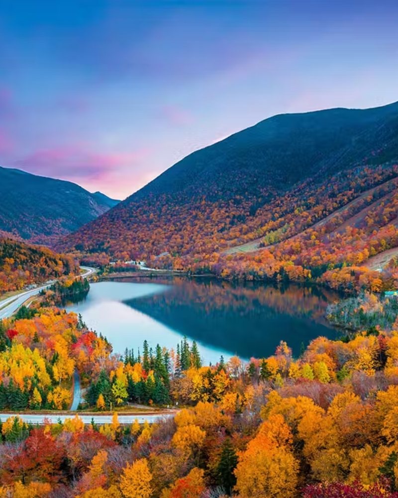 Autumn foliage around a mountain lake in New England