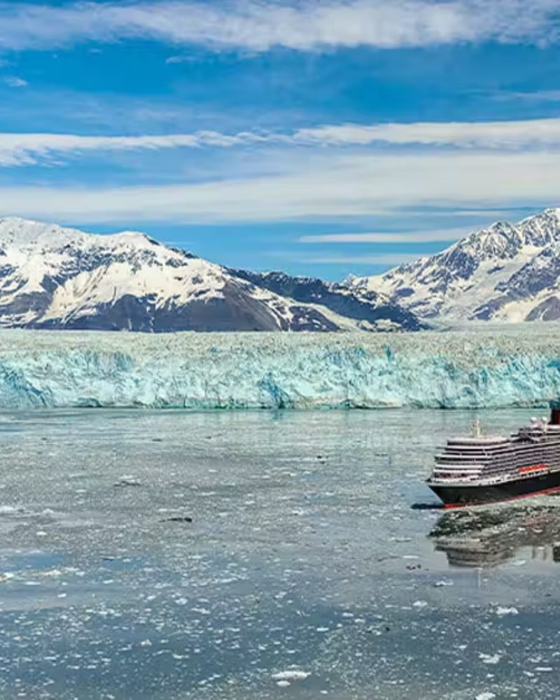 A Cunard ship sailing in front of a glacier