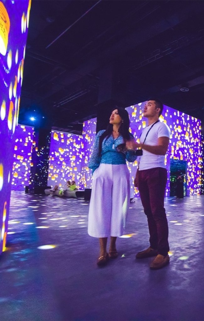 A couple inside an immersive light installation