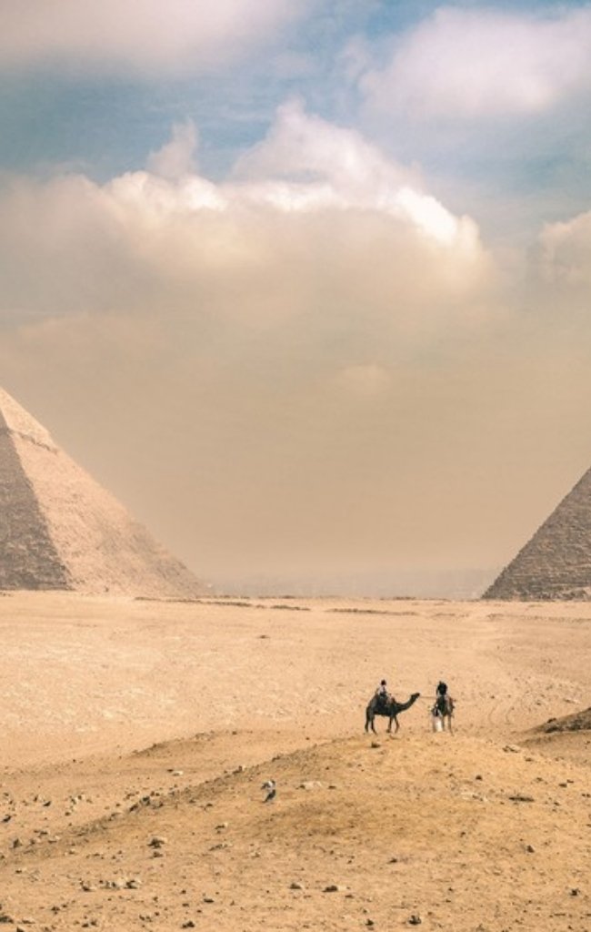 Camel riders near the pyramids of Giza