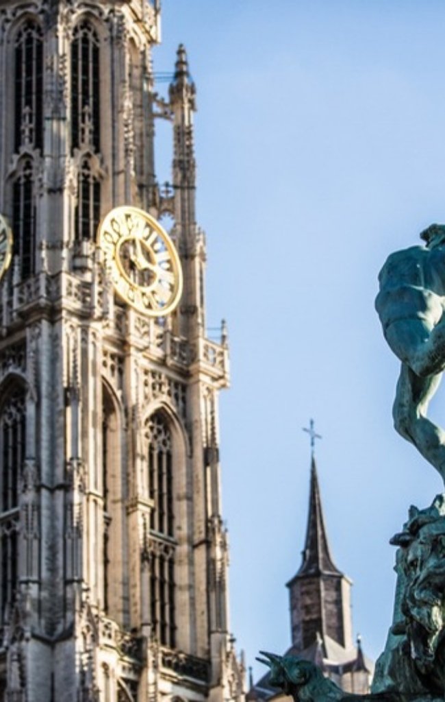 The Gothic spire of the Cathedral of Our Lady and the Brabo fountain in Antwerp