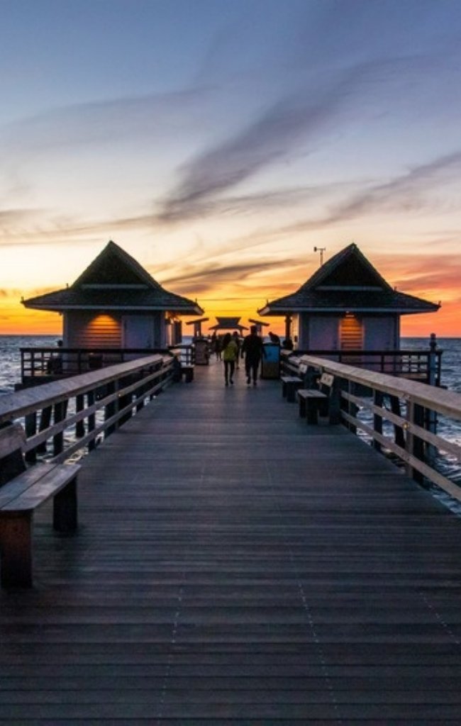 The Naples Pier stretching into the Gulf at sunset