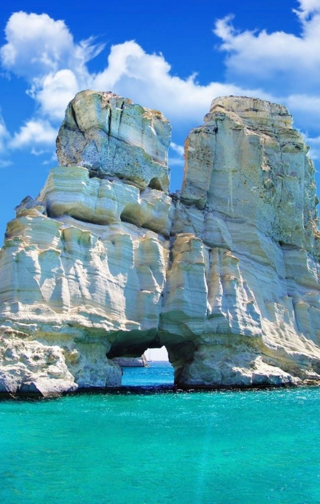 White rock formations above turquoise water in the Greek islands