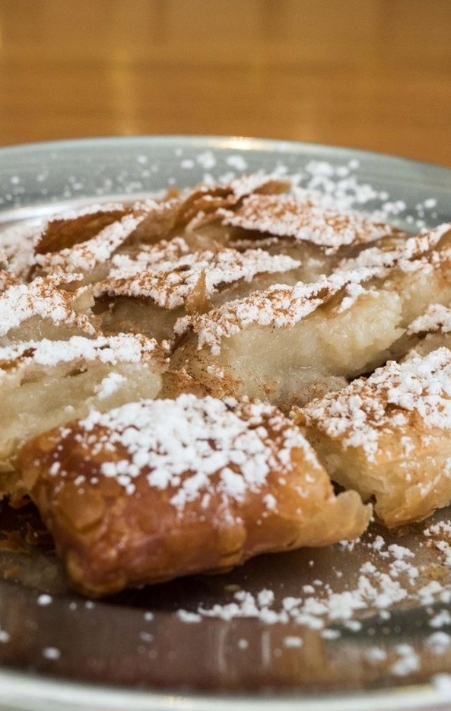 Flaky Greek pastry dusted with powdered sugar