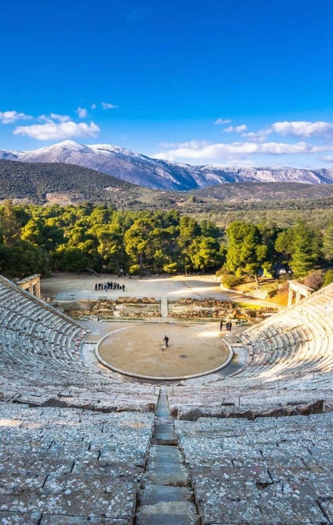 The ancient theatre of Epidaurus with mountains beyond