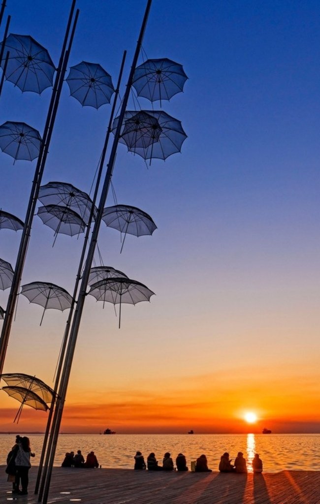 The Umbrellas sculpture on the Thessaloniki waterfront at sunset