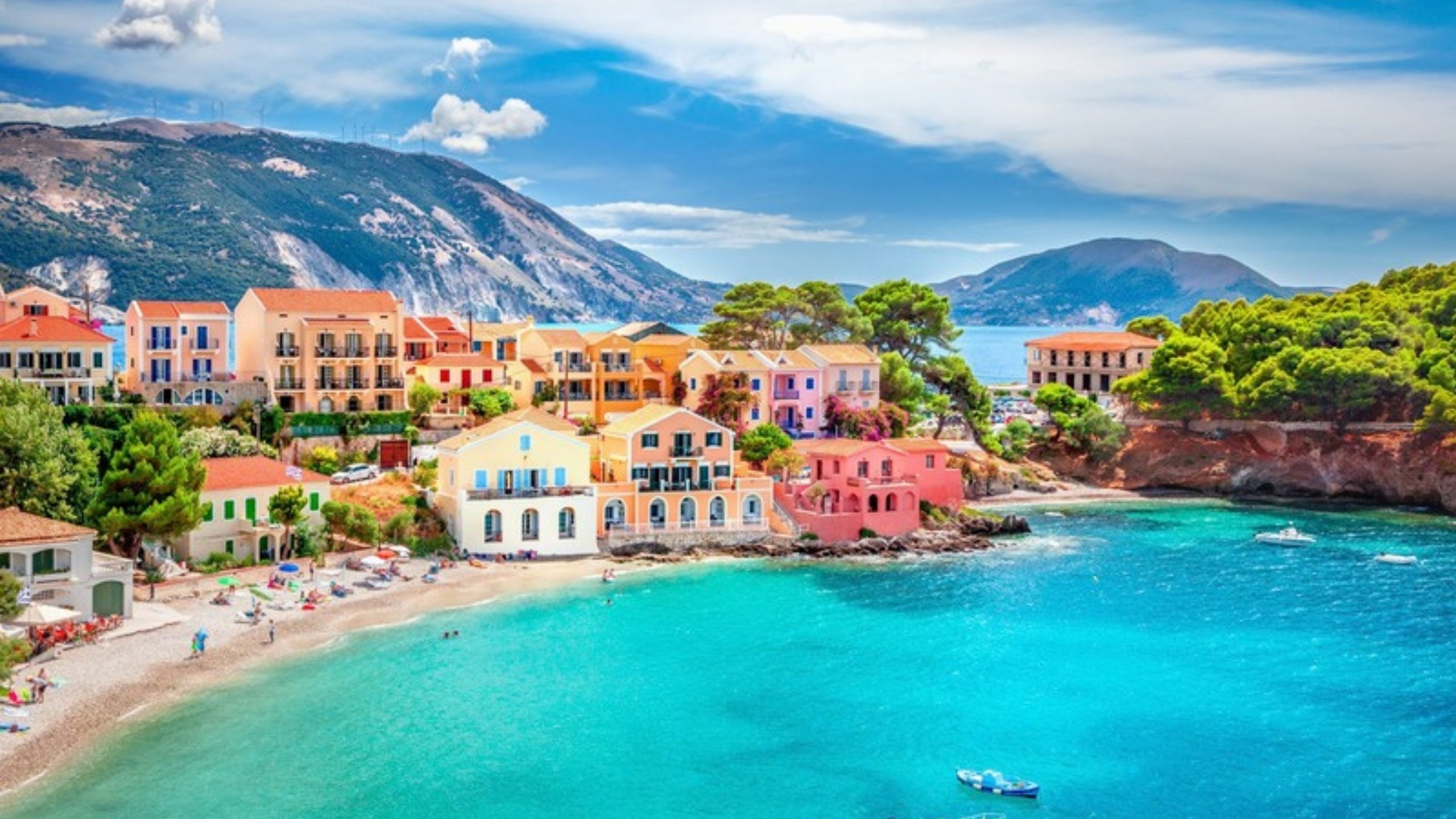 Pastel houses of Assos village above a turquoise bay on Kefalonia
