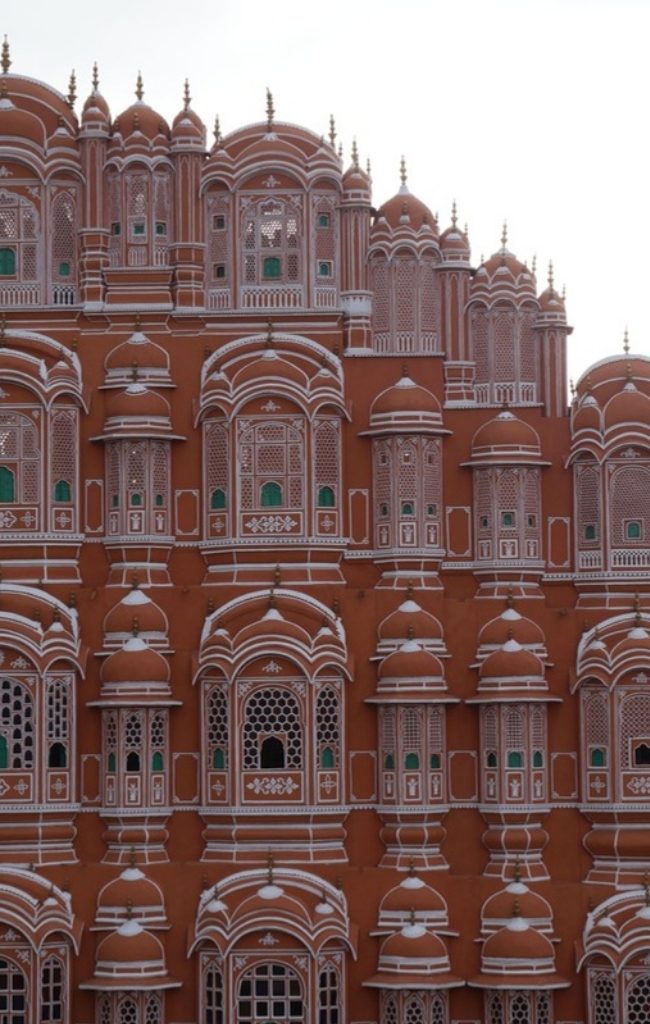 The pink facade of the Hawa Mahal in Jaipur