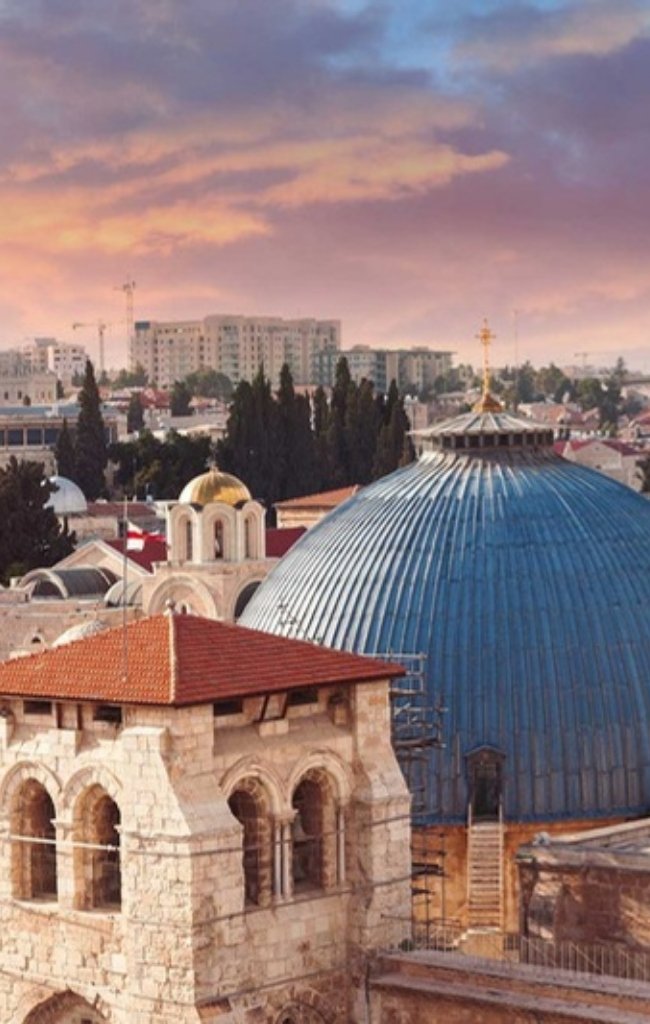 The Old City of Jerusalem at sunset with church towers and domes