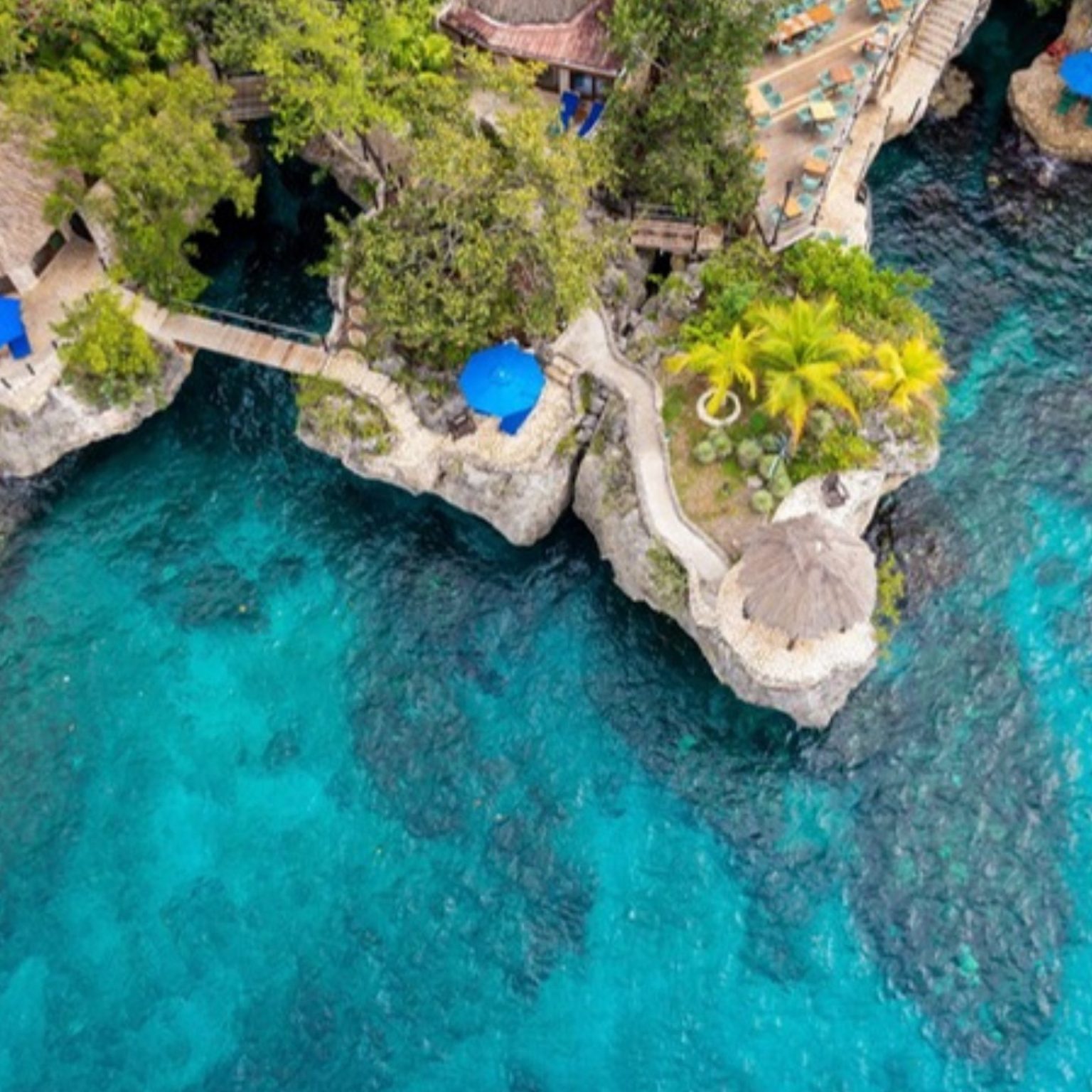 Cliffside terraces above turquoise water in Negril, Jamaica
