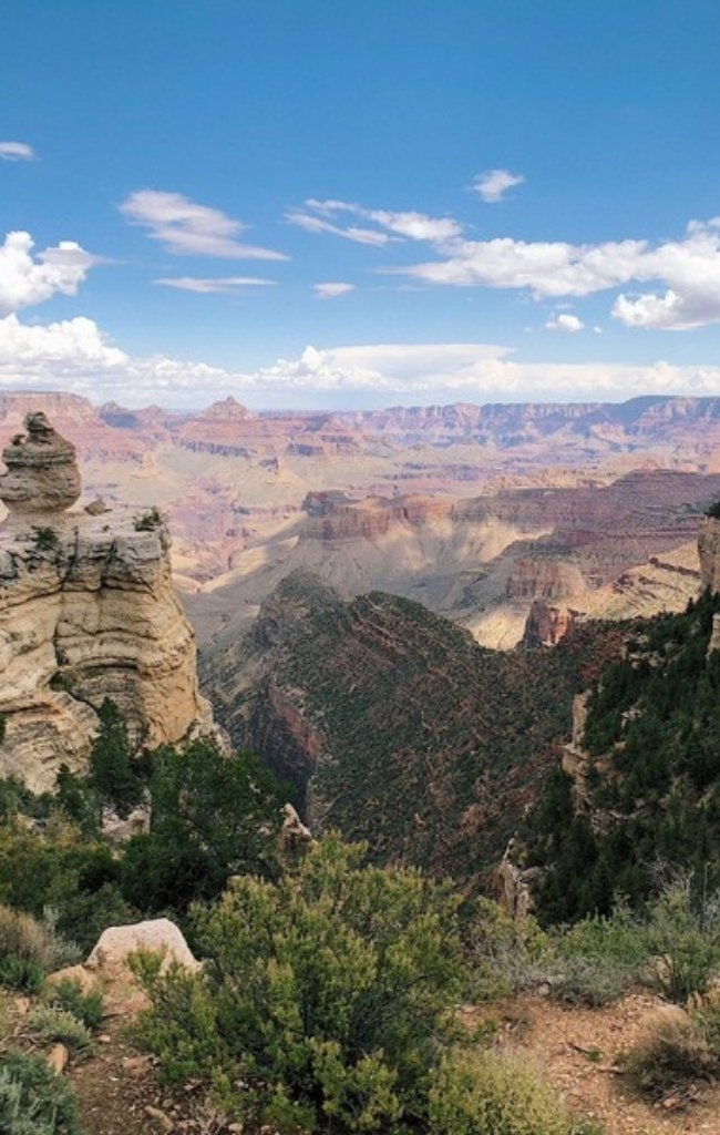 Layered red cliffs of the Grand Canyon under a blue sky