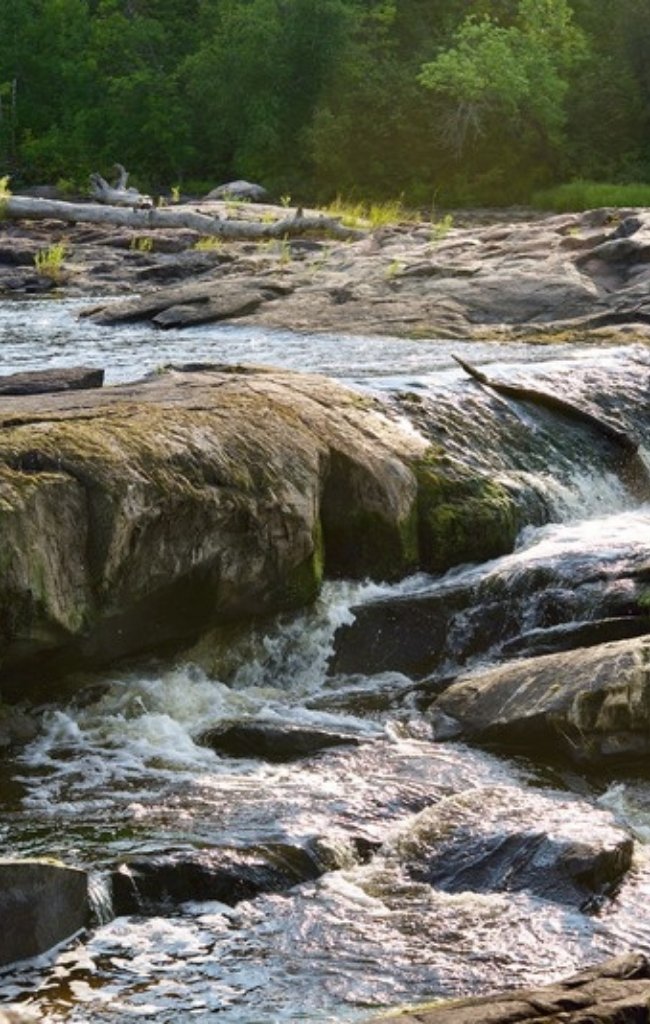 A waterfall over rocks in the Manitoba forest