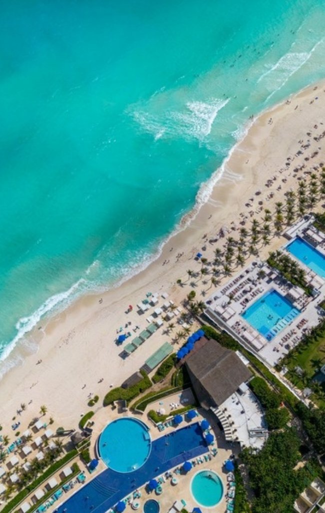 An aerial view of beachfront resort pools in Cancún