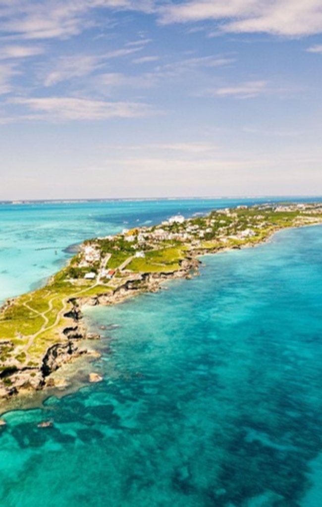 An aerial view of the narrow tip of Isla Mujeres in turquoise water