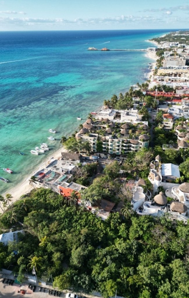 An aerial view of the beachfront and turquoise water in Playa del Carmen