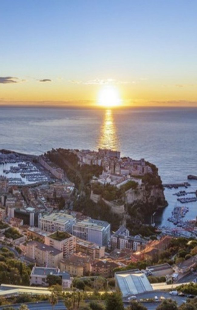 The Rock of Monaco and its harbor at sunset