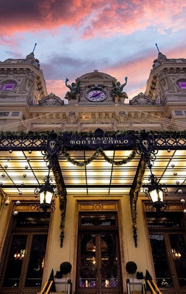 The illuminated facade of the Casino de Monte-Carlo at sunset