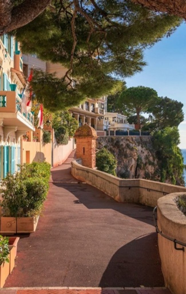 A sunny promenade with a stone sentry box in Monaco's old town