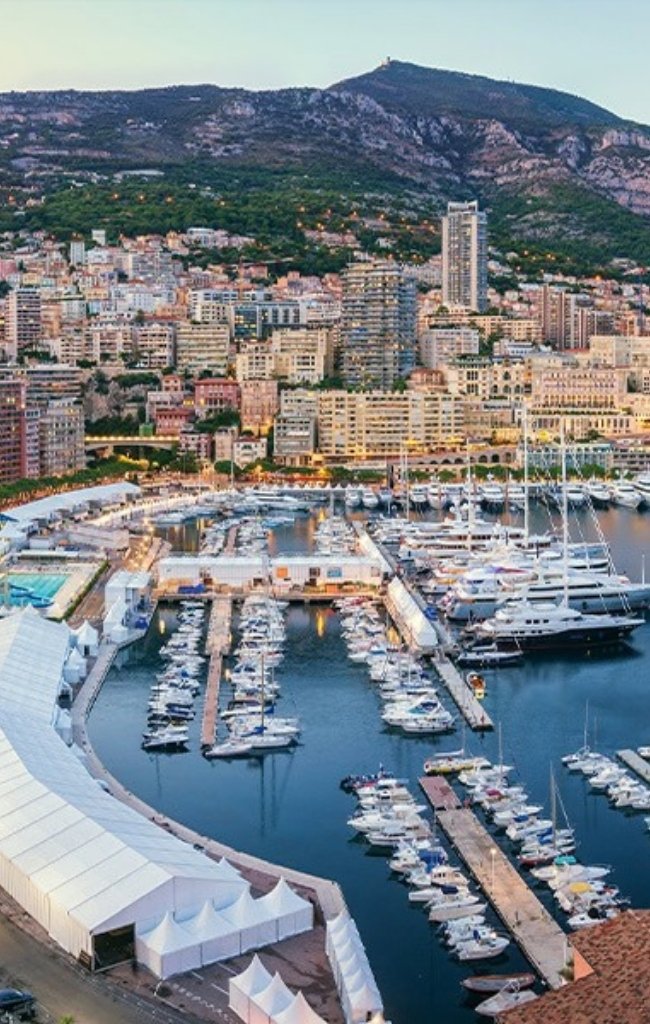 Yachts in Port Hercule below the city at dusk