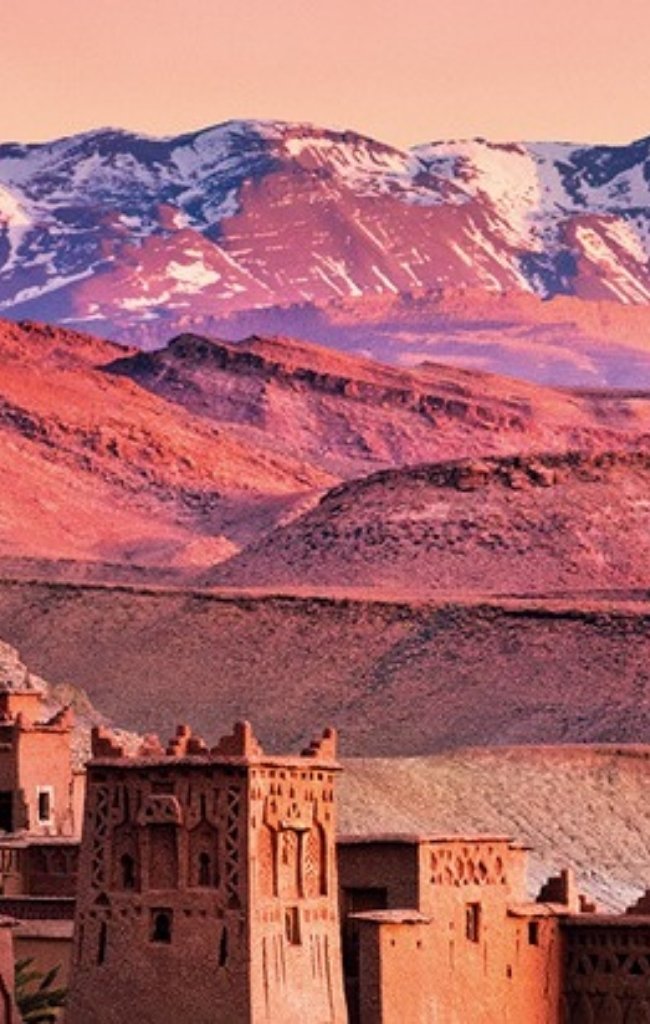 The kasbah of Ait Benhaddou below the snowy High Atlas