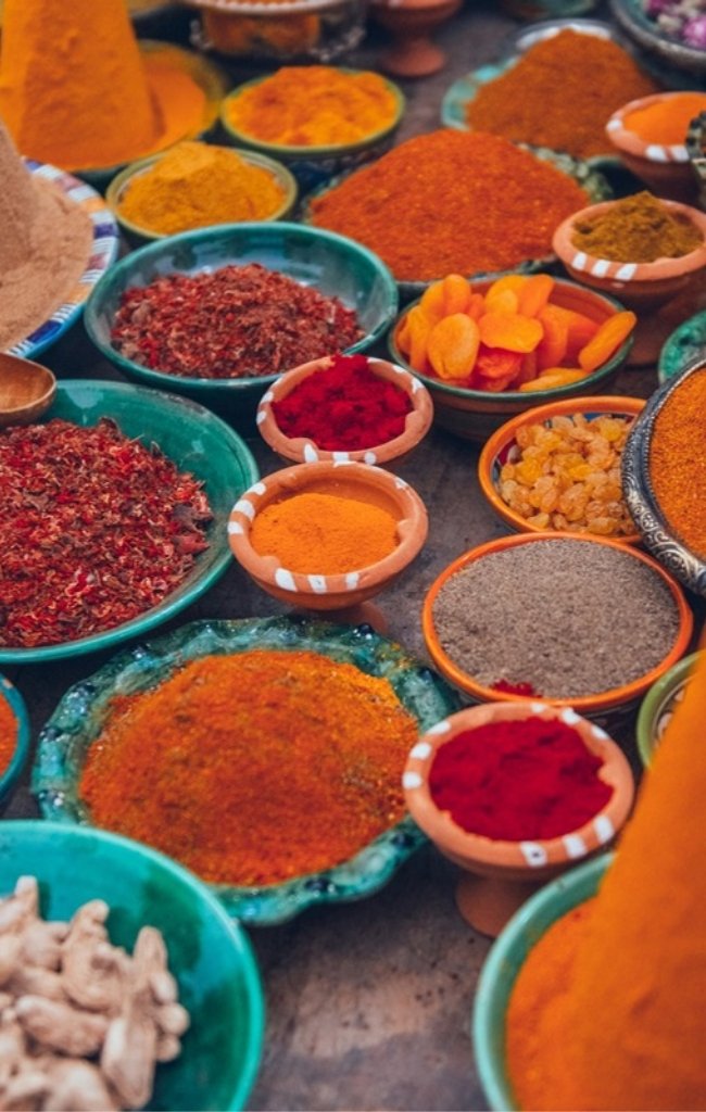 Mounds of colorful spices for sale in a Moroccan market