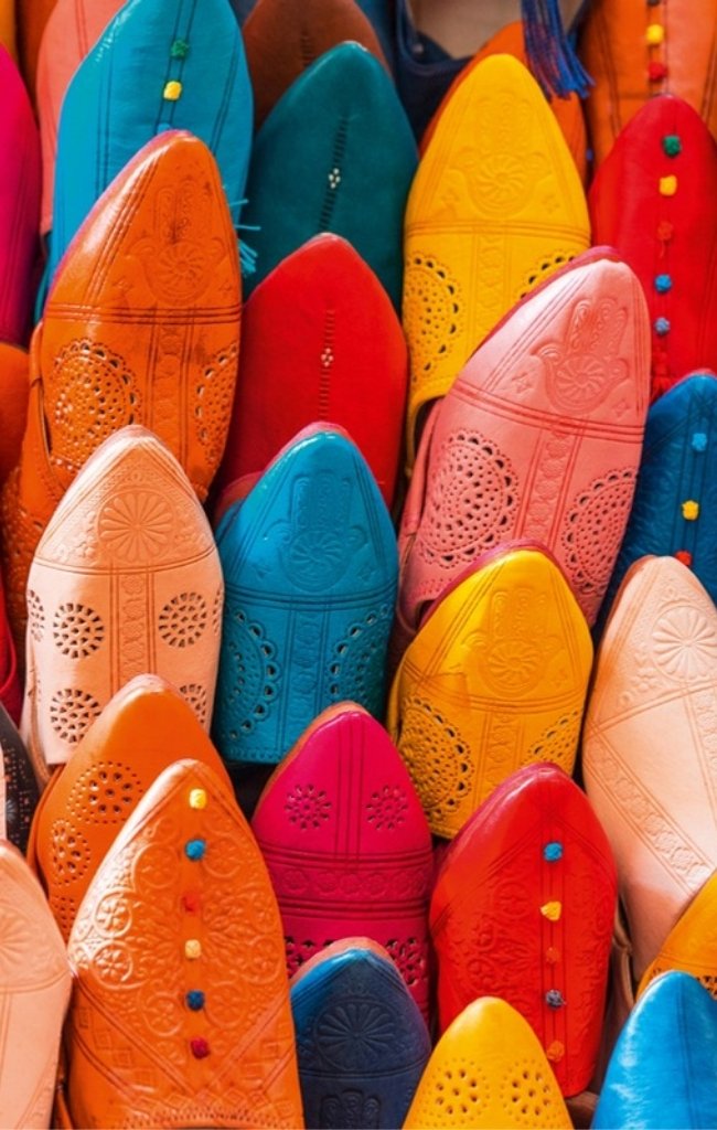 Rows of colorful leather babouche slippers in a souk