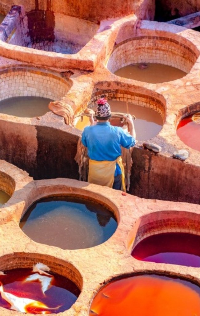 Workers among the dye pits of the Chouara tannery in Fes