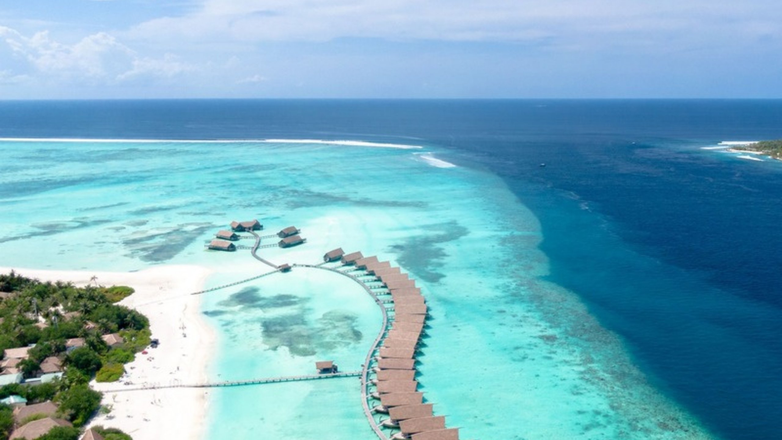 Overwater villas above a turquoise lagoon in the Maldives