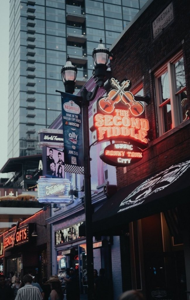 Neon signs of honky-tonks lighting up Lower Broadway at night