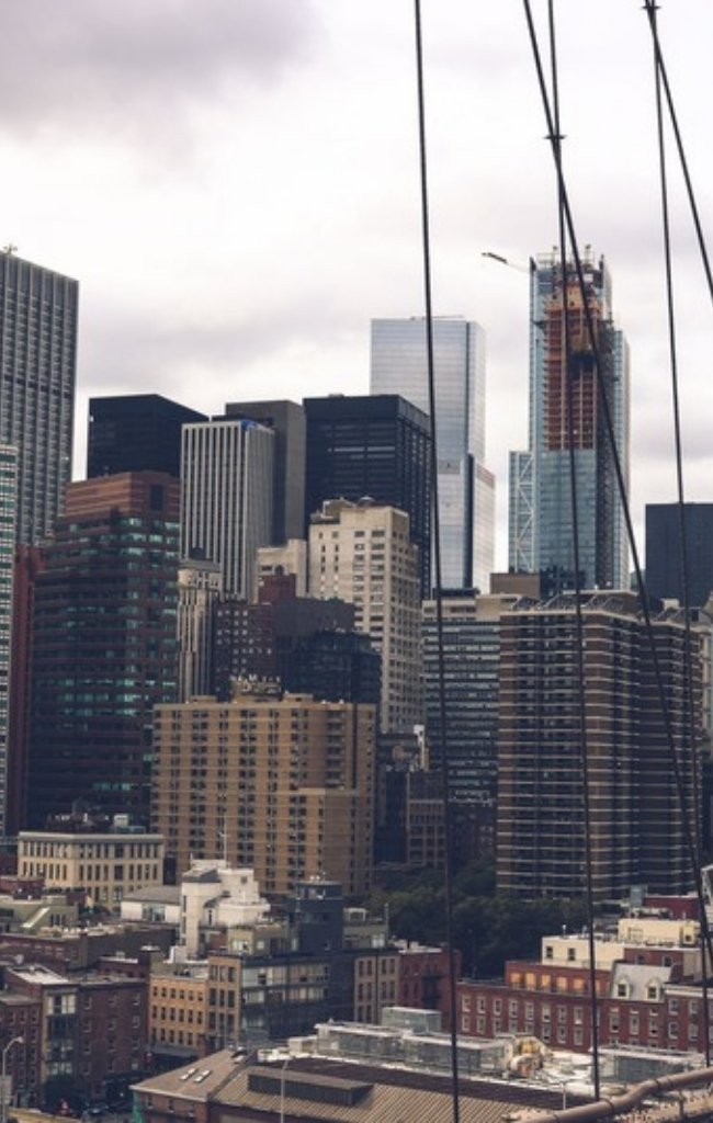 Lower Manhattan towers seen through the cables of the Brooklyn Bridge