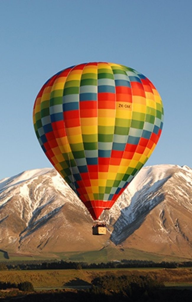 A colorful hot air balloon over the Southern Alps in Canterbury
